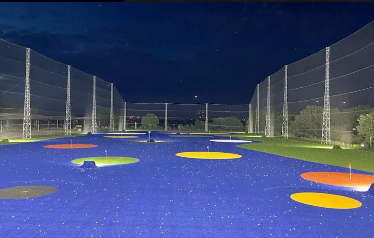 Illuminated outdoor target areas at the Good Time Golfin range at night