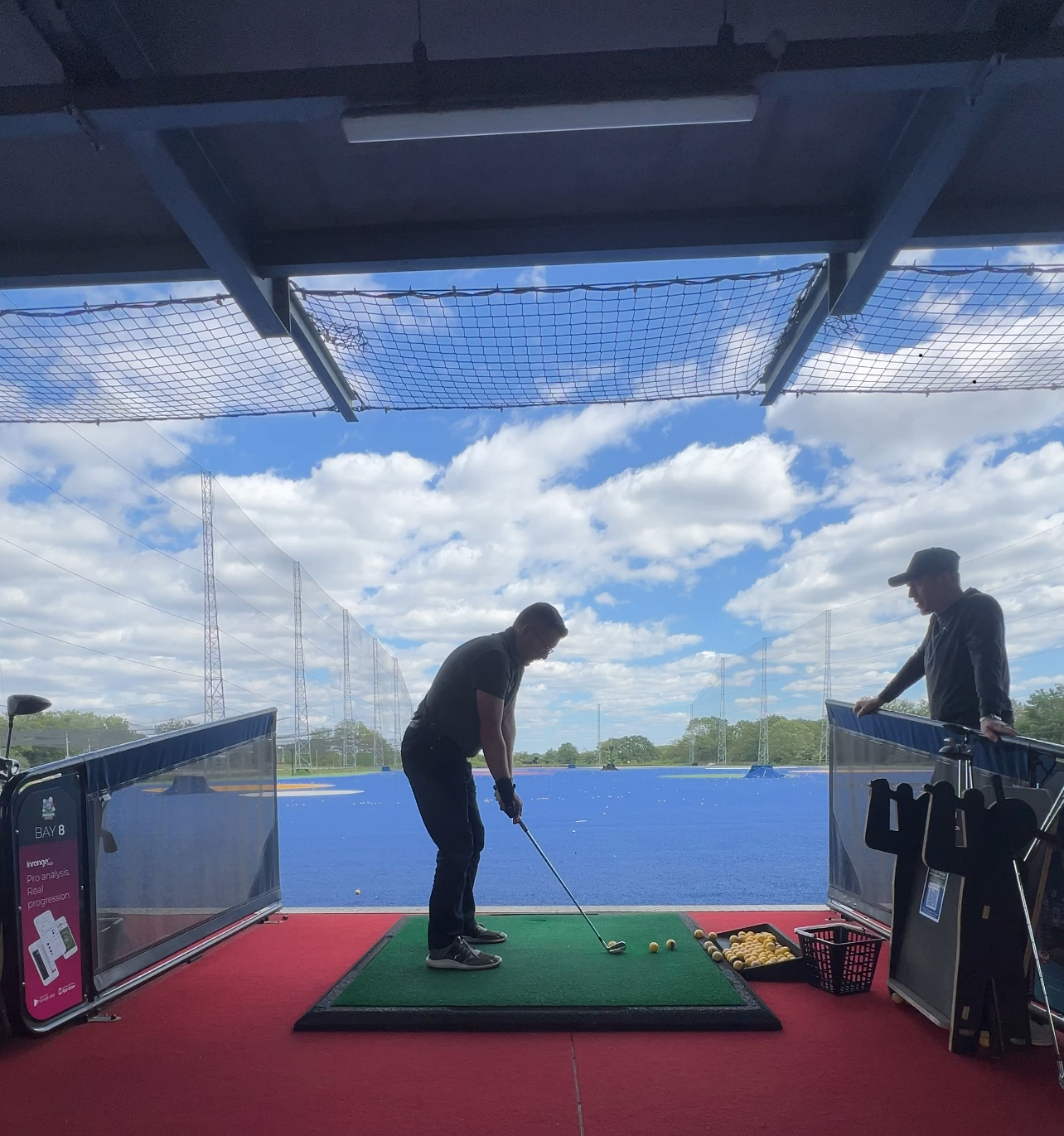 Golfer working with Mark at the open-air range